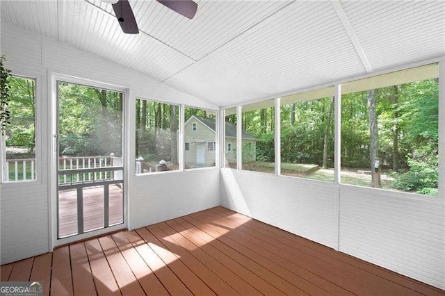 unfurnished sunroom featuring ceiling fan