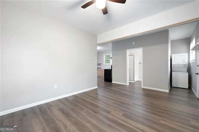 unfurnished living room featuring baseboards, ceiling fan, and dark wood-style floors