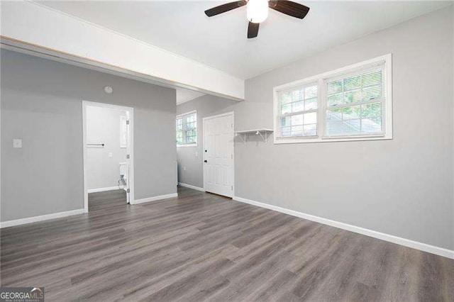 unfurnished living room with ceiling fan, baseboards, and wood finished floors