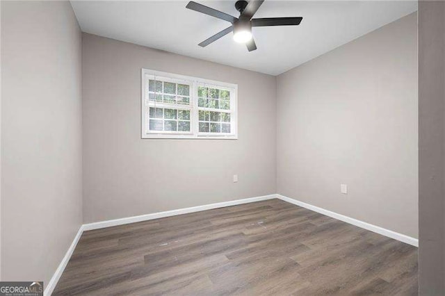unfurnished room featuring baseboards, wood finished floors, and a ceiling fan