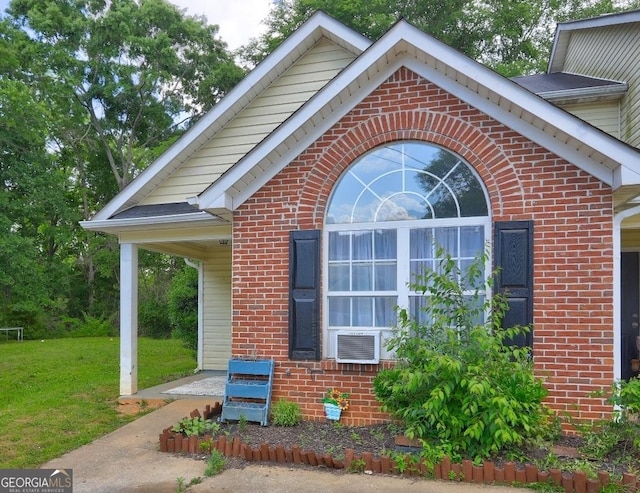 172 Evergreen Dr, Jackson, GA 30233 - view of side of home with brick siding, a yard, and cooling unit