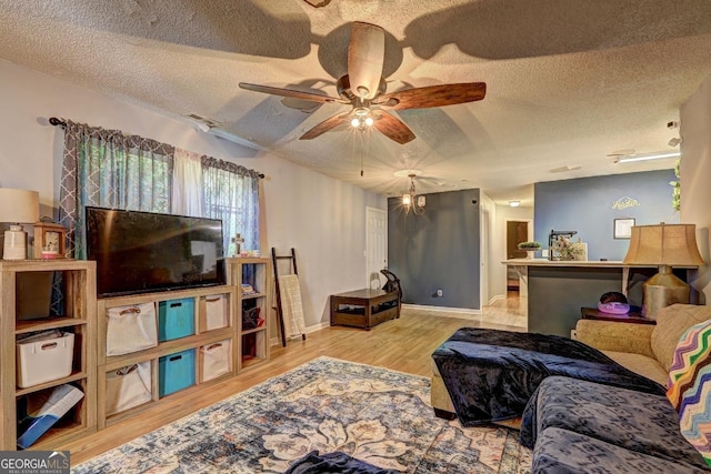 172 Evergreen Dr, Jackson, GA 30233 - living room with visible vents, a textured ceiling, ceiling fan, and wood finished floors