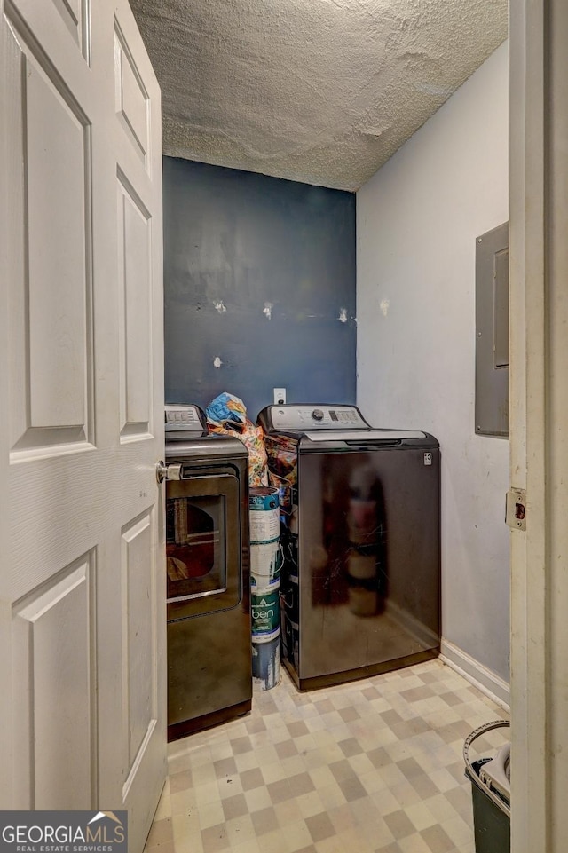 172 Evergreen Dr, Jackson, GA 30233 - clothes washing area featuring laundry area, a textured ceiling, tile patterned floors, electric panel, and washing machine and clothes dryer