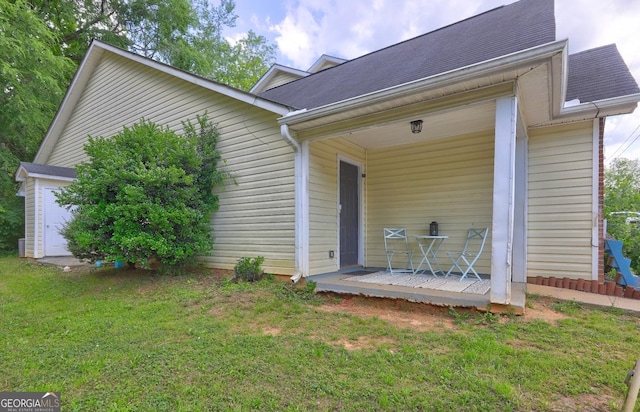 172 Evergreen Dr, Jackson, GA 30233 - exterior space featuring a shingled roof, a yard, and a porch