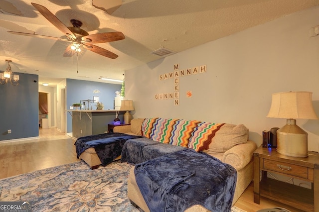 172 Evergreen Dr, Jackson, GA 30233 - living room featuring a textured ceiling, ceiling fan, wood finished floors, and visible vents
