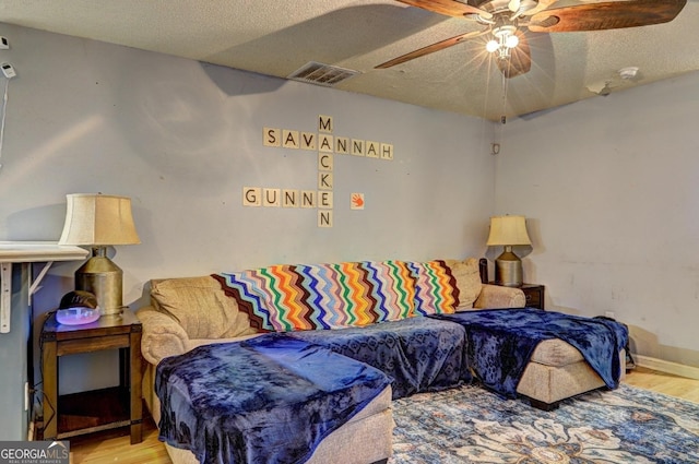 172 Evergreen Dr, Jackson, GA 30233 - living area with visible vents, a ceiling fan, a textured ceiling, and wood finished floors