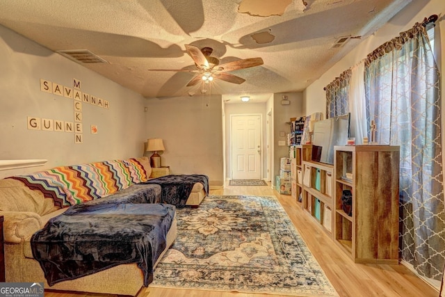 172 Evergreen Dr, Jackson, GA 30233 - living room with visible vents, a textured ceiling, ceiling fan, and wood finished floors