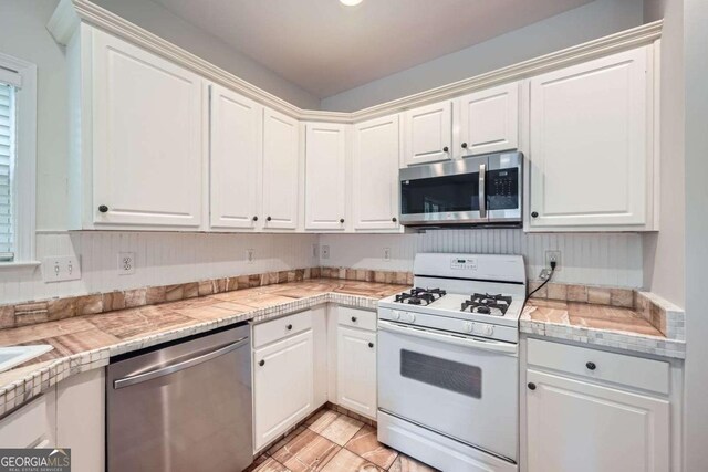 1259 Crescentwood Ln, Decatur, GA 30032 - kitchen featuring white cabinetry and appliances with stainless steel finishes
