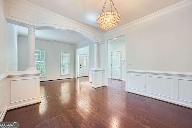 1259 Crescentwood Ln, Decatur, GA 30032 - unfurnished dining area featuring a decorative wall, wood-type flooring, arched walkways, ornate columns, and ornamental molding