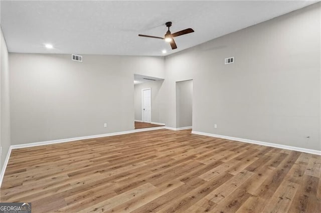 spare room with recessed lighting, a ceiling fan, light wood-style floors, and baseboards