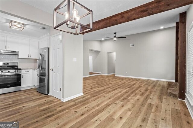 kitchen featuring appliances with stainless steel finishes, under cabinet range hood, ceiling fan, white cabinetry, and light wood-style floors