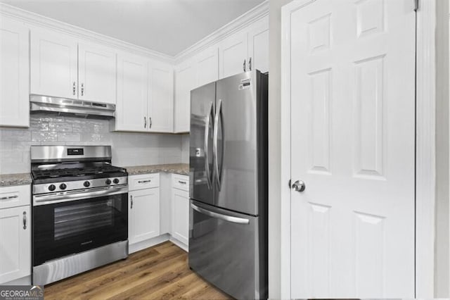 kitchen with stainless steel appliances, under cabinet range hood, white cabinetry, and light stone countertops