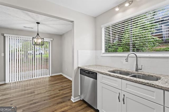 kitchen with dishwasher, a sink, plenty of natural light, and tasteful backsplash