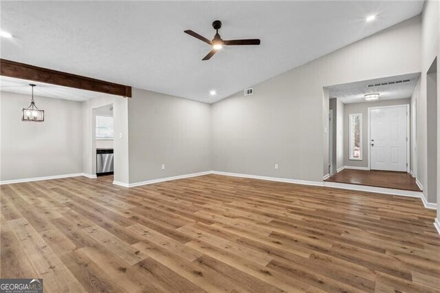 unfurnished living room featuring ceiling fan, wood finished floors, vaulted ceiling, baseboards, and recessed lighting