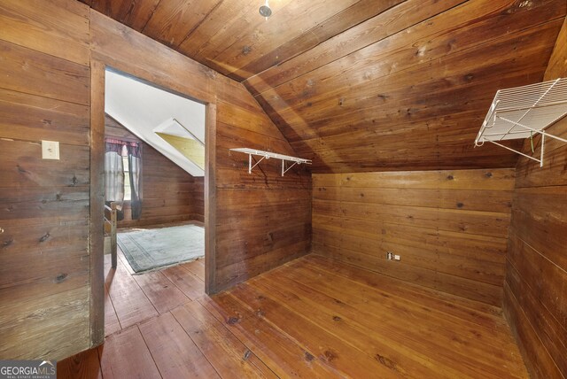 walk in closet featuring wood-type flooring and vaulted ceiling