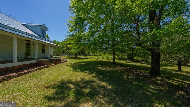 view of yard featuring covered porch