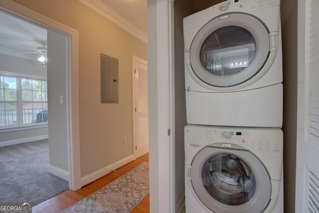 3204 Village Blvd SE, Rome, GA 30161 - washroom featuring stacked washing machine and dryer, ornamental molding, a ceiling fan, electric panel, and wood finished floors