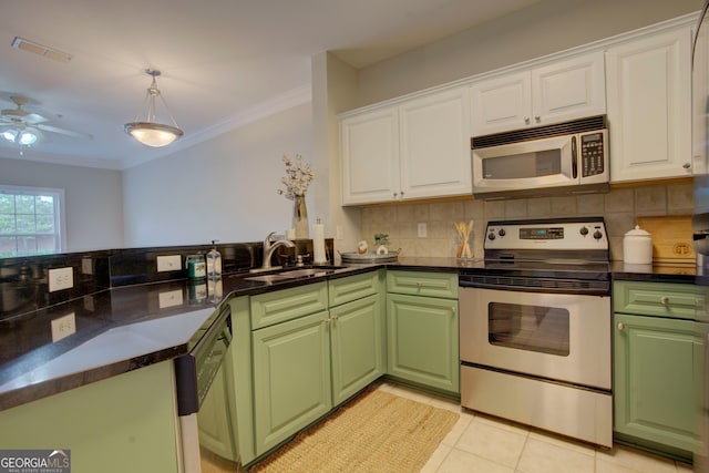 3204 Village Blvd SE, Rome, GA 30161 - kitchen featuring stainless steel appliances, white cabinets, crown molding, and decorative backsplash