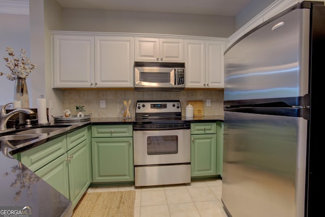 3204 Village Blvd SE, Rome, GA 30161 - kitchen featuring appliances with stainless steel finishes, white cabinetry, light tile patterned floors, and tasteful backsplash