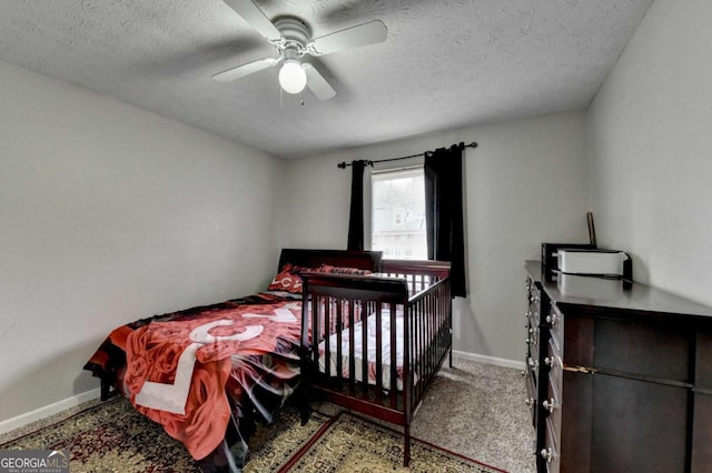 carpeted bedroom with baseboards, a textured ceiling, and ceiling fan