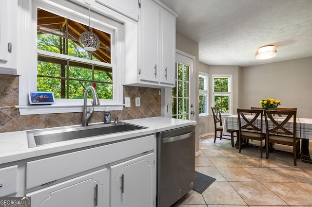 588 Peachtree Dr SE, White, GA 30184 - kitchen featuring stainless steel dishwasher, tasteful backsplash, white cabinets, and light tile patterned floors
