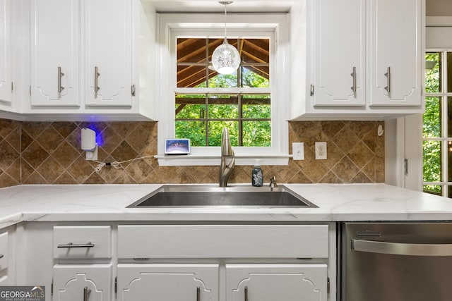 588 Peachtree Dr SE, White, GA 30184 - kitchen with stainless steel dishwasher, white cabinetry, decorative light fixtures, and plenty of natural light