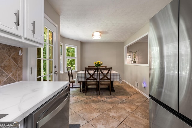 588 Peachtree Dr SE, White, GA 30184 - dining area featuring light tile patterned flooring and a textured ceiling