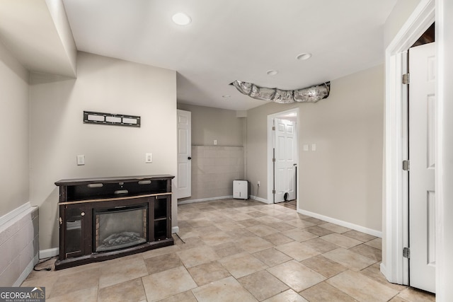 588 Peachtree Dr SE, White, GA 30184 - unfurnished living room featuring recessed lighting and a glass covered fireplace