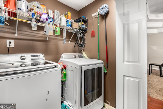 588 Peachtree Dr SE, White, GA 30184 - washroom with washing machine and clothes dryer and wood finished floors