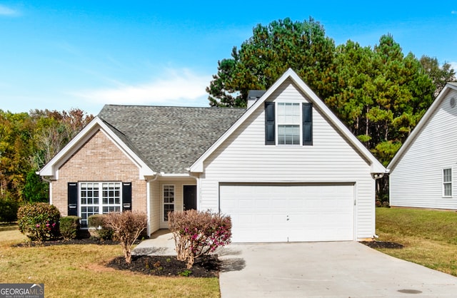 1716 Anniston Dr, Mcdonough, GA 30253 - traditional-style house featuring a front lawn, driveway, brick siding, and a shingled roof