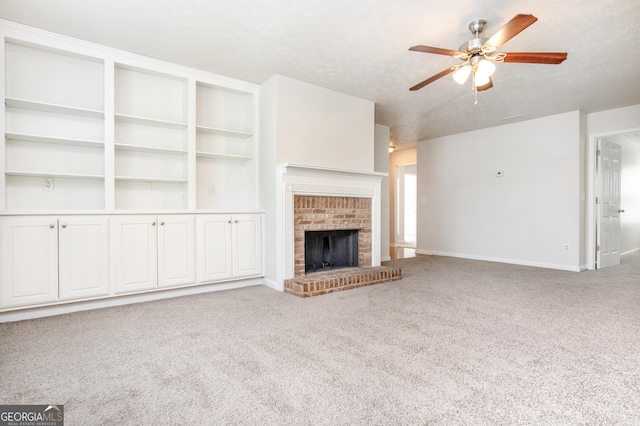 1716 Anniston Dr, Mcdonough, GA 30253 - unfurnished living room featuring ceiling fan, carpet floors, baseboards, a fireplace, and a textured ceiling