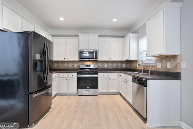 5244 Carrington Park Dr, Powder Springs, GA 30127 - kitchen with a sink, appliances with stainless steel finishes, white cabinets, and dark countertops
