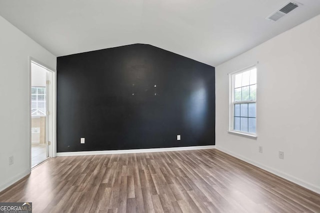 5244 Carrington Park Dr, Powder Springs, GA 30127 - empty room with baseboards, lofted ceiling, wood finished floors, and visible vents