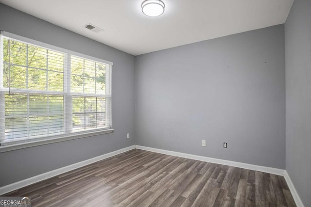 5244 Carrington Park Dr, Powder Springs, GA 30127 - unfurnished room featuring visible vents, dark wood-style flooring, and baseboards