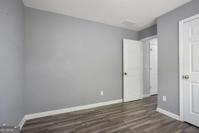 5244 Carrington Park Dr, Powder Springs, GA 30127 - unfurnished bedroom featuring baseboards, visible vents, and dark wood-type flooring