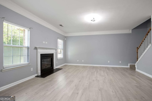 5244 Carrington Park Dr, Powder Springs, GA 30127 - unfurnished living room with crown molding, visible vents, wood finished floors, and a healthy amount of sunlight