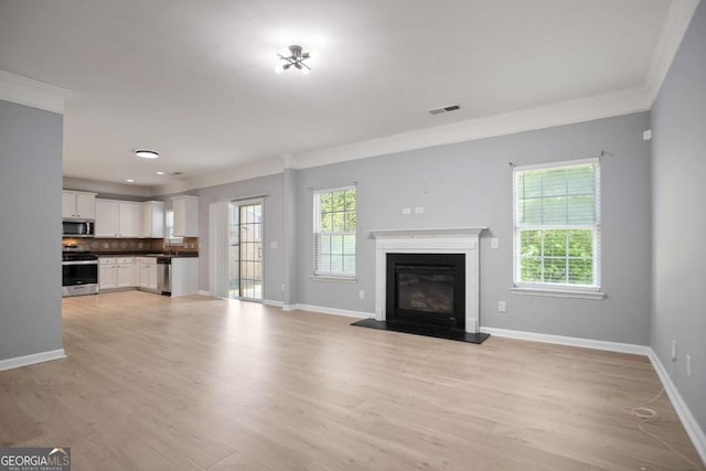 5244 Carrington Park Dr, Powder Springs, GA 30127 - unfurnished living room with crown molding, baseboards, visible vents, and light wood-style floors