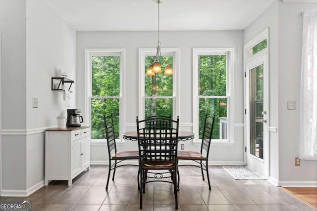 1126 Gate Post Ct, Powder Springs, GA 30127 - dining space featuring tile patterned flooring, a chandelier, and a healthy amount of sunlight