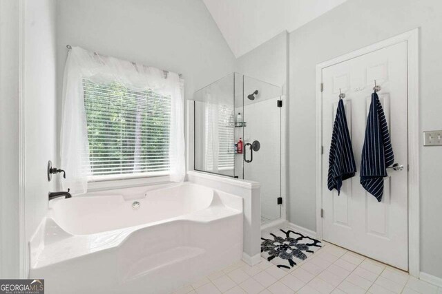 1126 Gate Post Ct, Powder Springs, GA 30127 - full bathroom featuring tile patterned flooring, baseboards, a shower stall, lofted ceiling, and a bath