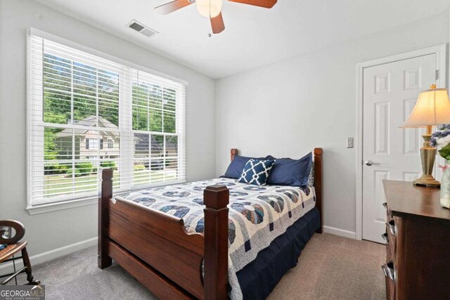 1126 Gate Post Ct, Powder Springs, GA 30127 - bedroom with light colored carpet, baseboards, and multiple windows