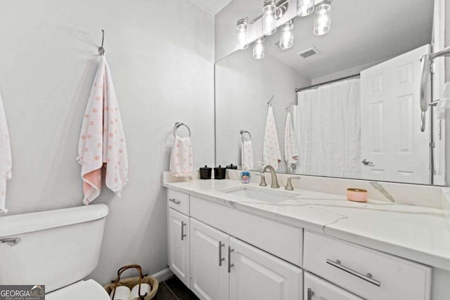 1126 Gate Post Ct, Powder Springs, GA 30127 - bathroom with toilet, baseboards, visible vents, and vanity