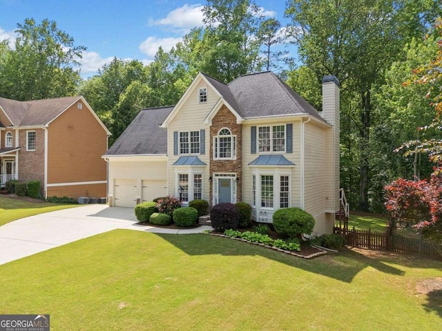 1126 Gate Post Ct, Powder Springs, GA 30127 - view of front of home with fence, a garage, a front yard, a chimney, and driveway