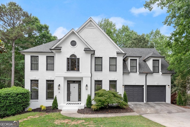 view of front of property featuring a garage, brick siding, a front lawn, concrete driveway, and a shingled roof