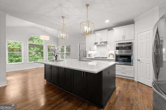 kitchen featuring a chandelier, light countertops, stainless steel appliances, and a sink