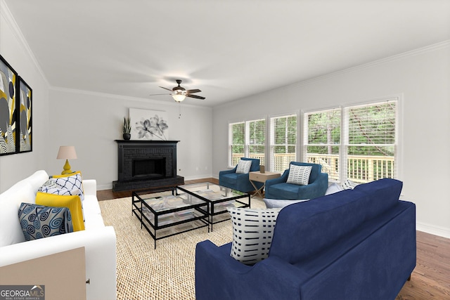 living room with a ceiling fan, baseboards, ornamental molding, and wood finished floors