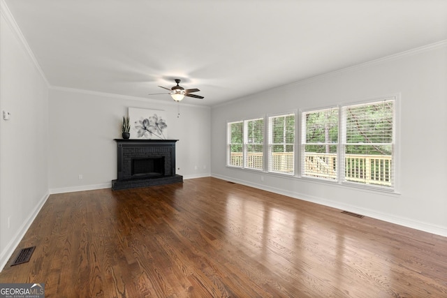 unfurnished living room featuring ceiling fan, dark wood finished floors, ornamental molding, and baseboards