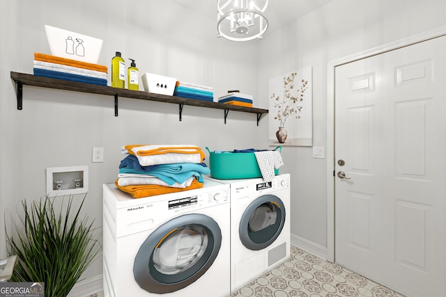 laundry area with an inviting chandelier, baseboards, laundry area, and washing machine and clothes dryer