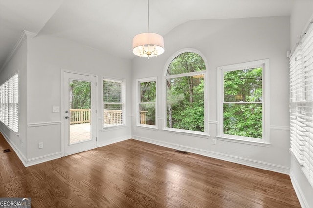 unfurnished sunroom with baseboards, vaulted ceiling, a healthy amount of sunlight, and wood finished floors