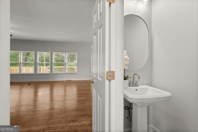 bathroom with baseboards and wood finished floors