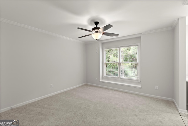 unfurnished room featuring crown molding, baseboards, light carpet, and ceiling fan